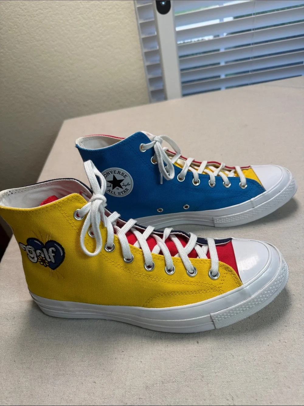 Converse All Star Chuck Golf Wang High Top Sneakers in Yellow, Blue, and Red.